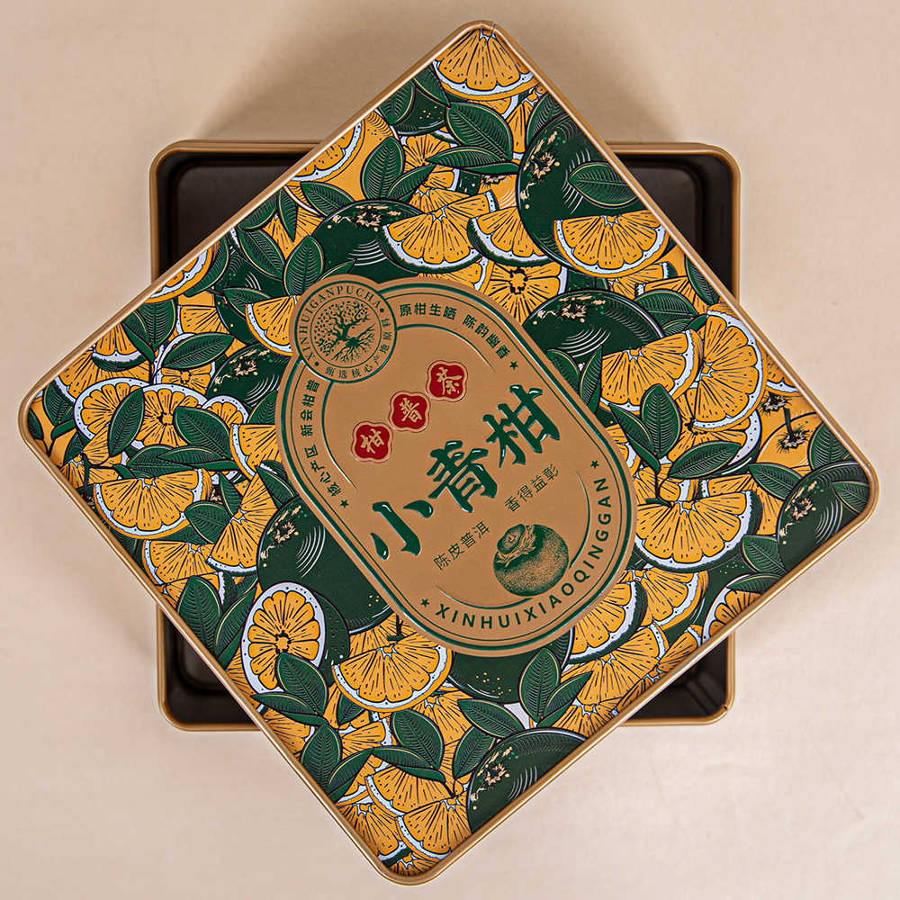 This citrus-patterned lid box seals Xinhui tea's fragrance within its iron casing