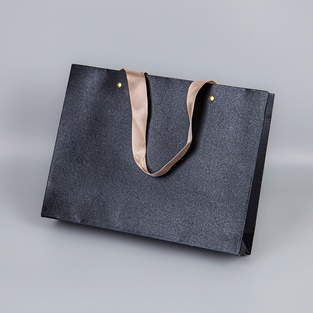 A black and gold tote bag that brings understated elegance to everyday life